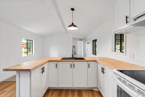 a kitchen with a sink cabinets and window