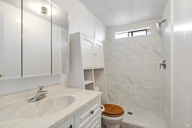 a bathroom with a sink toilet and shower