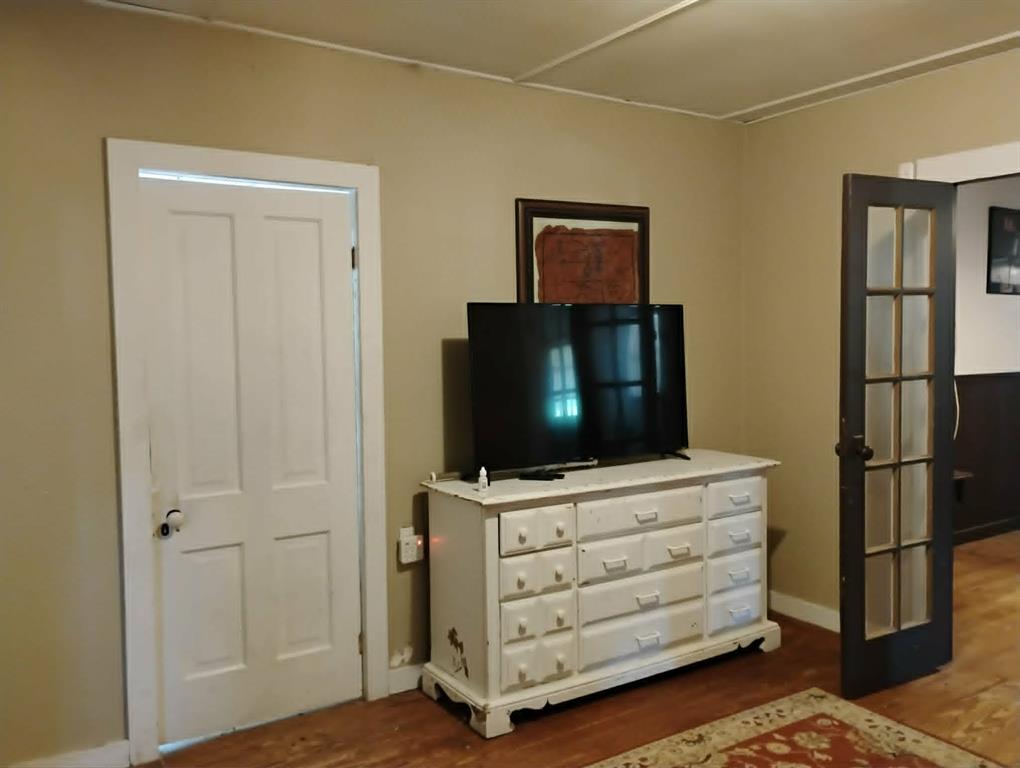 763 Frontier Street Bowie, TX 76230 - Photo 7 of 28 a room with a flat screen tv dressers and a dresser