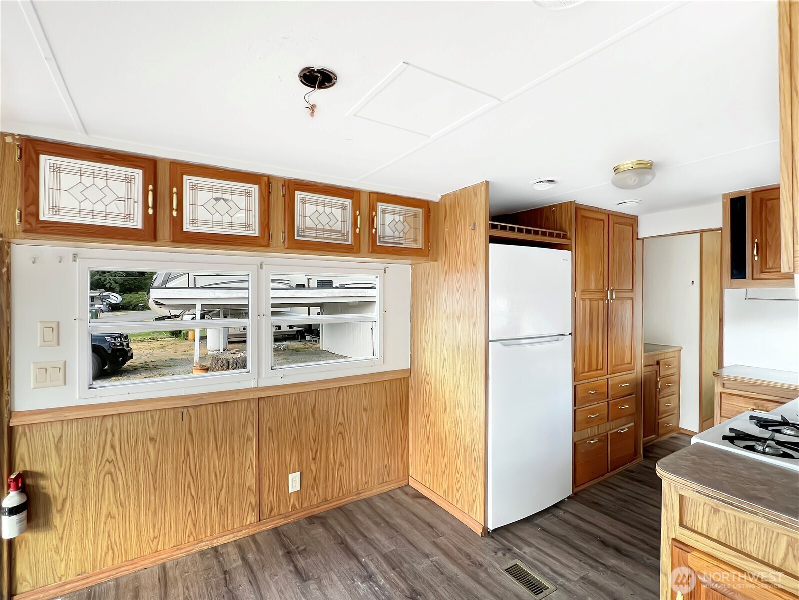 10900 Kuhlman Road Southeast, Unit 4 Olympia, WA 98513 - Photo 4 of 11 a kitchen with stainless steel appliances granite countertop a refrigerator a stove and a wooden cabinets