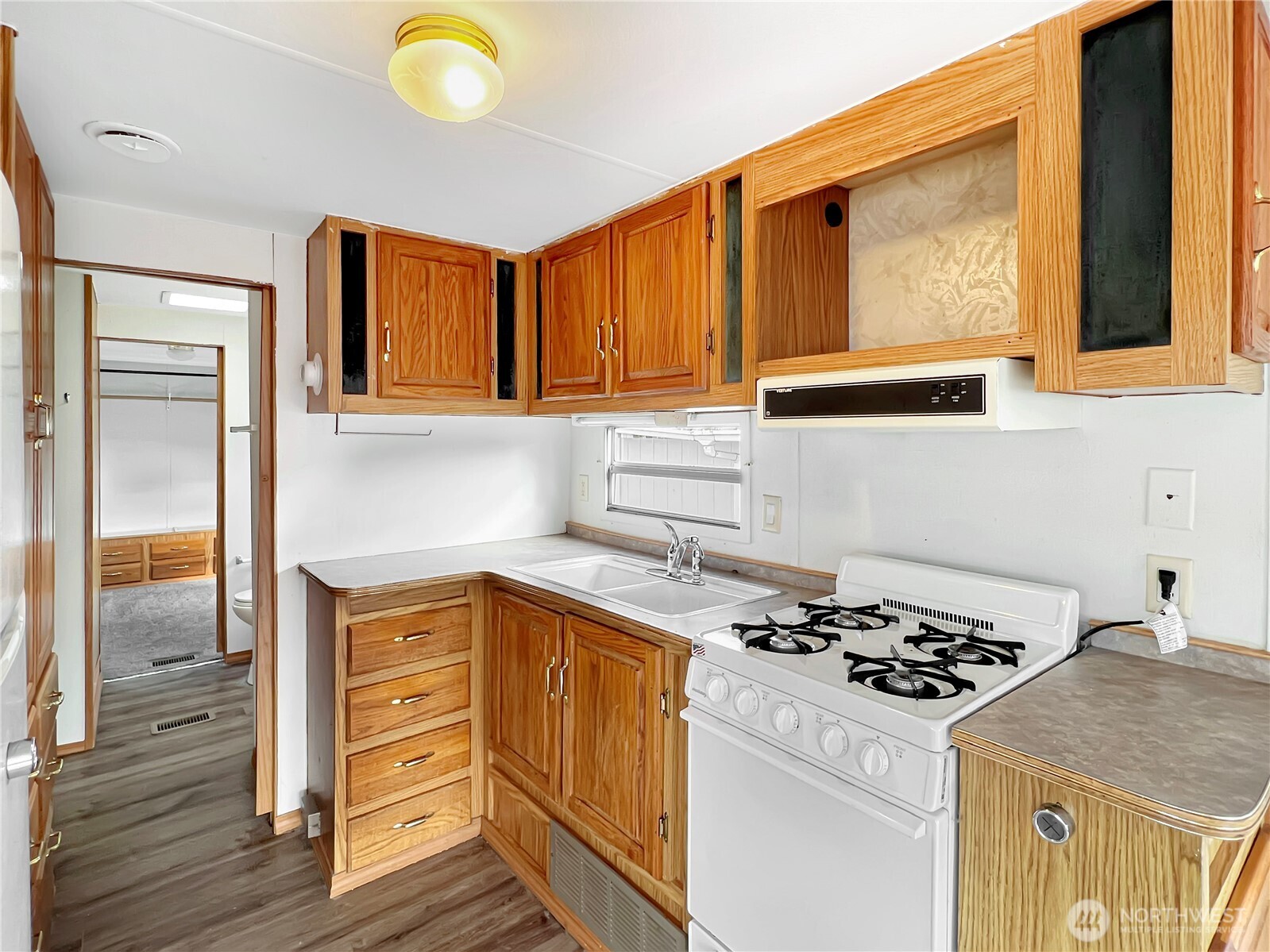 10900 Kuhlman Road Southeast, Unit 4 Olympia, WA 98513 - Photo 5 of 11 a kitchen with a stove and a microwave