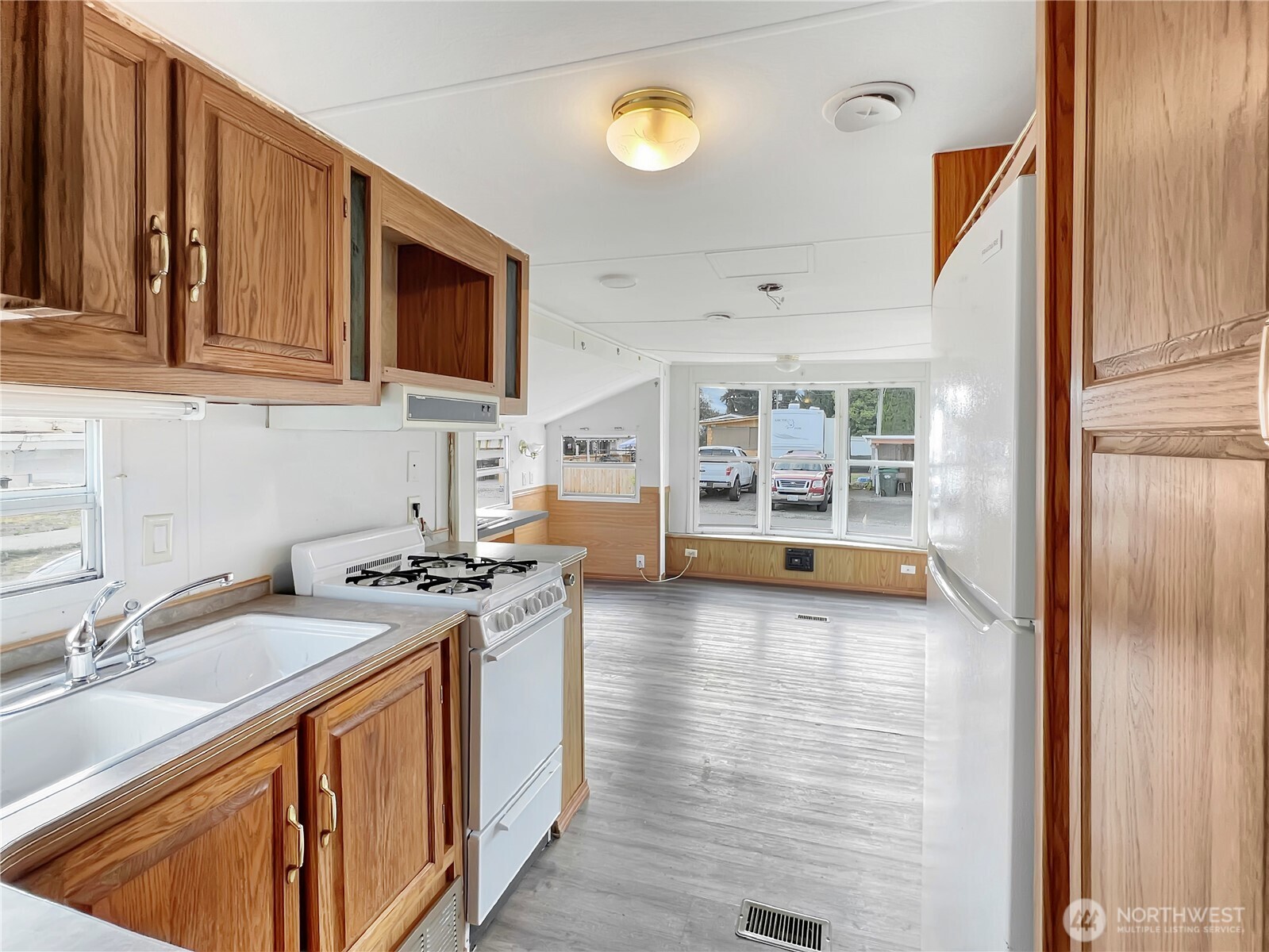 10900 Kuhlman Road Southeast, Unit 4 Olympia, WA 98513 - Photo 6 of 11 a kitchen with stainless steel appliances granite countertop a stove a sink and a microwave