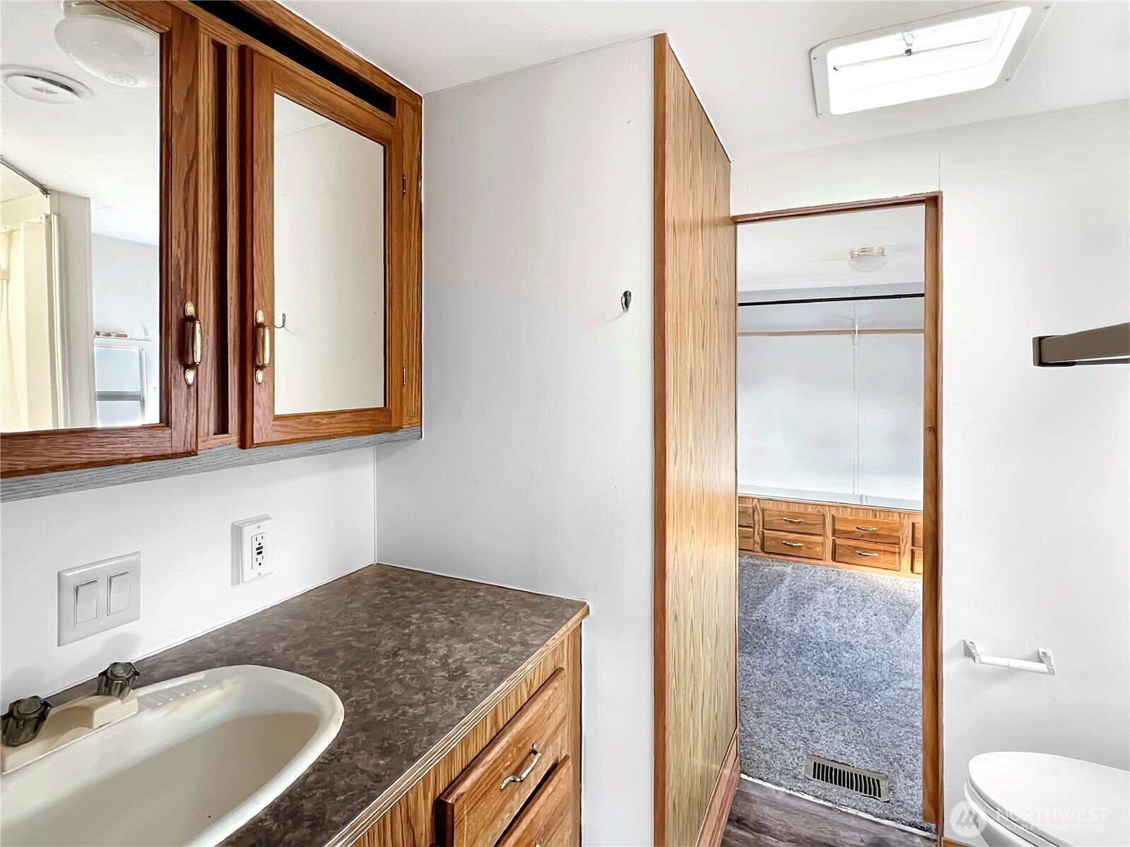 10900 Kuhlman Road Southeast, Unit 4 Olympia, WA 98513 - Photo 7 of 11 a bathroom with a granite countertop sink and a mirror