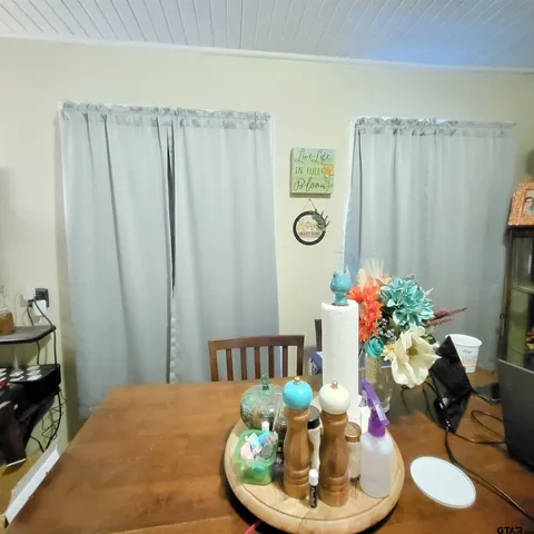a dining room with furniture and wooden floor