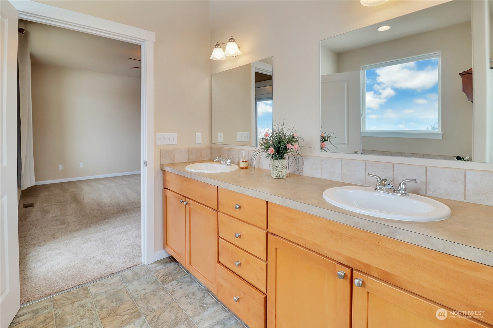 183 Garrett Loop Chehalis, WA 98532 - Photo 12 of 35 a bathroom with double sink and a mirror