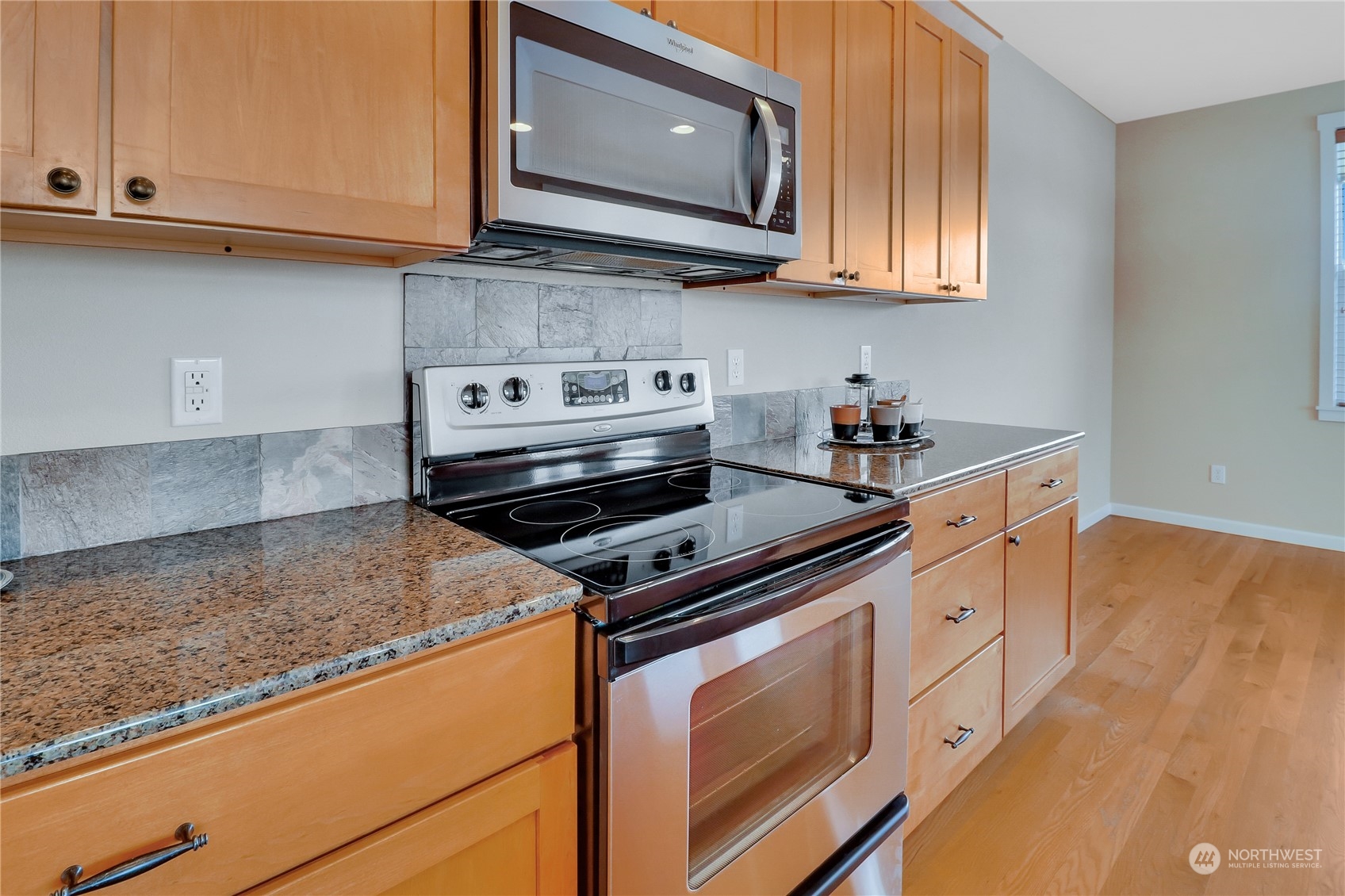 183 Garrett Loop Chehalis, WA 98532 - Photo 7 of 35 a kitchen with granite countertop cabinets stainless steel appliances and a wooden floor