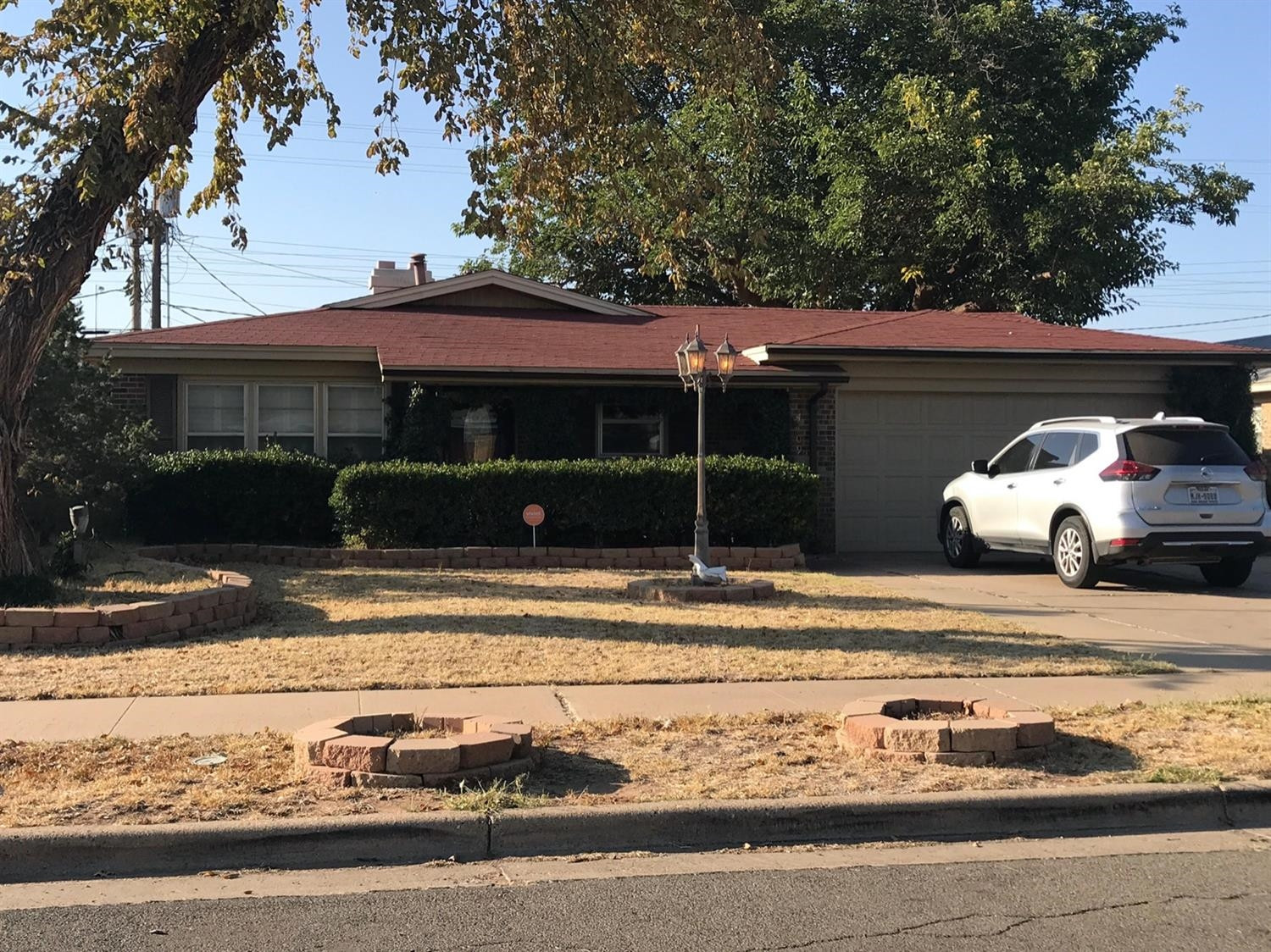 4409 49th Street Lubbock, TX 79414 - Photo 1 of 1 a front view of a house with garden