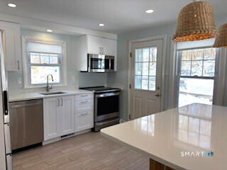 18 Buttonball Road Old Lyme, CT 06371 - Photo 5 of 20 a kitchen with granite countertop a stove and a refrigerator