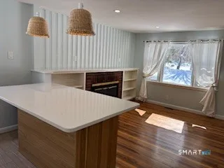 a kitchen with a wooden floor and a window