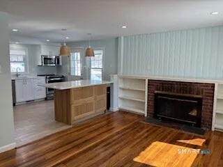 a kitchen with a stove fireplace and a window