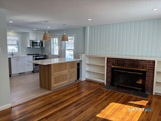 18 Buttonball Road Old Lyme, CT 06371 - Photo 9 of 20 a kitchen with a stove fireplace and a window