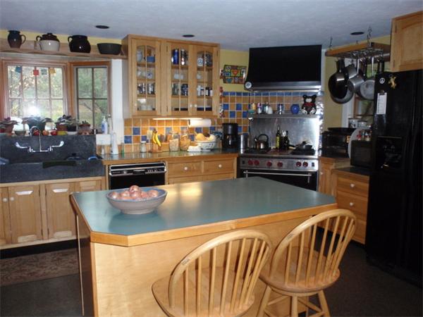 483 Montague Road Amherst, MA 01002 - Photo 6 of 30 a kitchen with a table and chairs in it