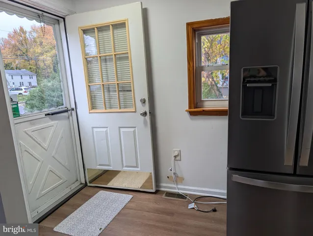 a view of front door with wooden floor