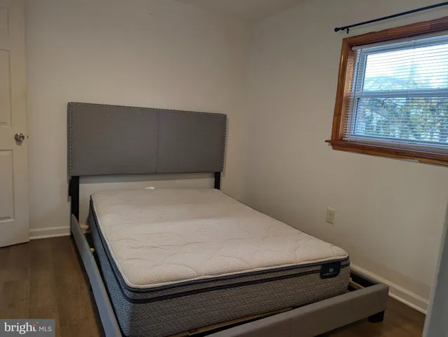 a bed sitting in a bedroom next to a window