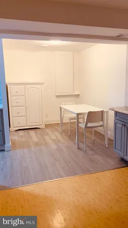 a view of a room with a table and chairs