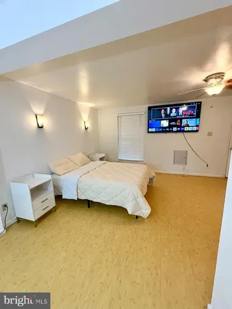 a bedroom with a bed and a couch