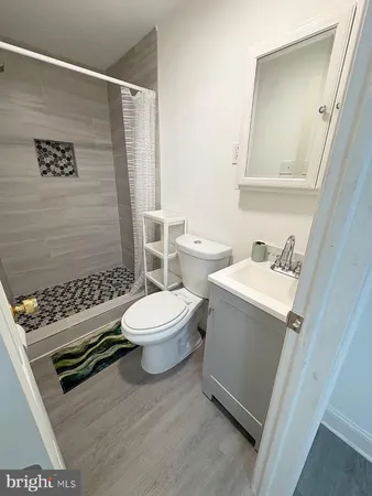 a white toilet sitting next to a bathroom sink