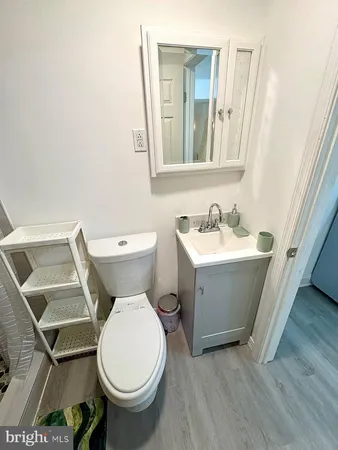 a bathroom with a toilet sink and mirror
