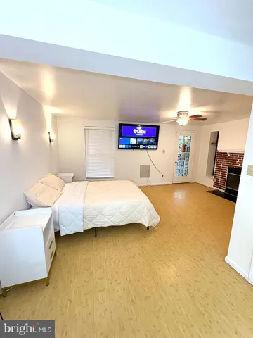 a spacious bedroom with a bed and a couch