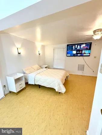 a bedroom with a bed and wall painting