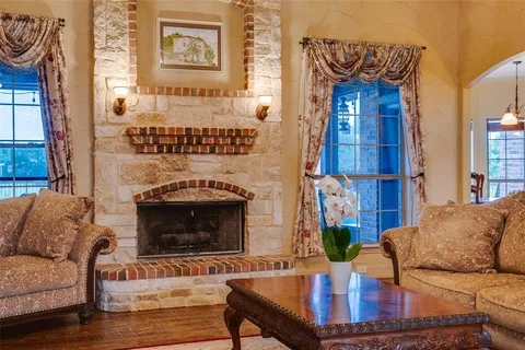 a living room with furniture a fireplace and a painting