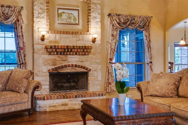 a living room with furniture a fireplace and a painting