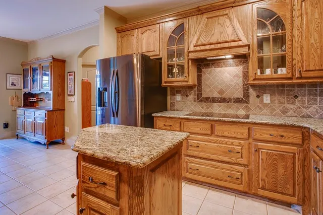 a kitchen with refrigerator and cabinets