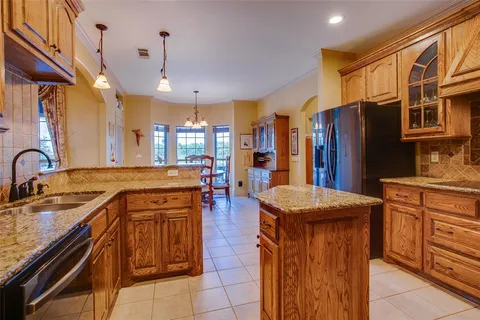 a kitchen with stainless steel appliances granite countertop sink stove and refrigerator