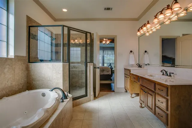 a bathroom with a tub sink and mirror