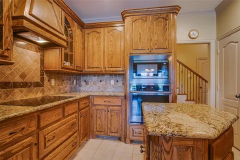a kitchen with a stove and a wooden cabinets