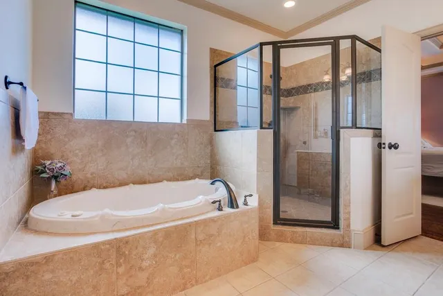 a bathroom with a tub and shower
