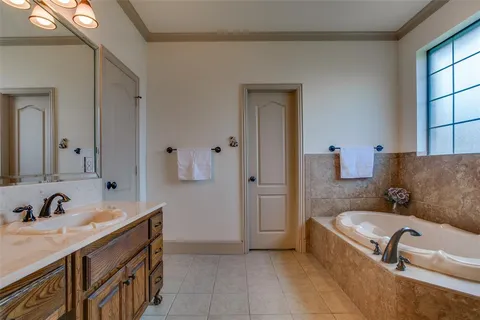 a bathroom with a tub sink and mirror
