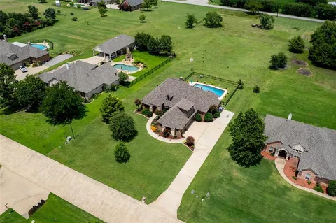 an aerial view of a house with outdoor space