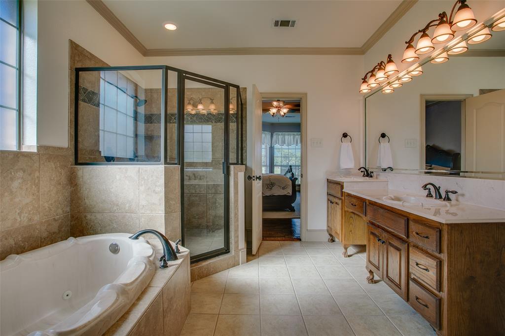 10044 Dennehy Drive Talty, TX 75126 - Photo 21 of 40 a bathroom with a tub sink and mirror