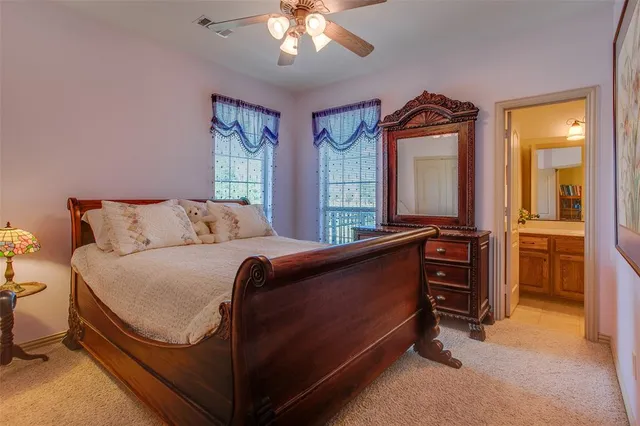 a bedroom with a bed and a large mirror on dresser