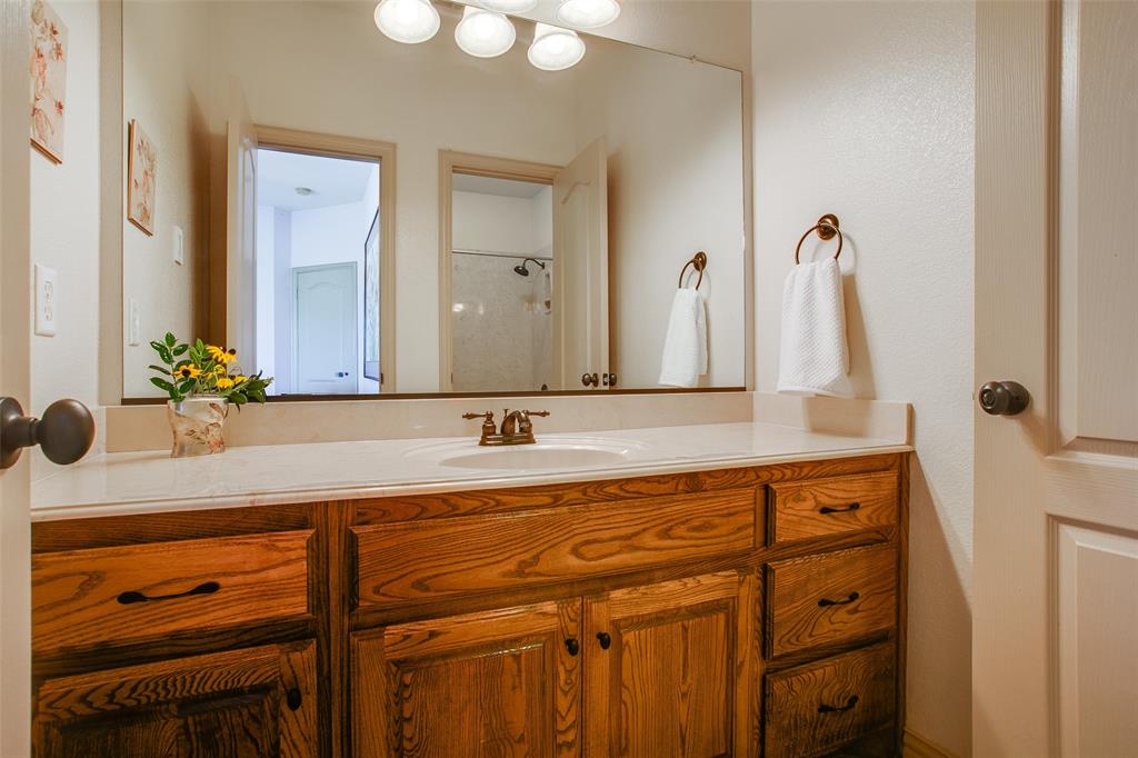 10044 Dennehy Drive Talty, TX 75126 - Photo 24 of 40 a bathroom with a sink vanity and mirror