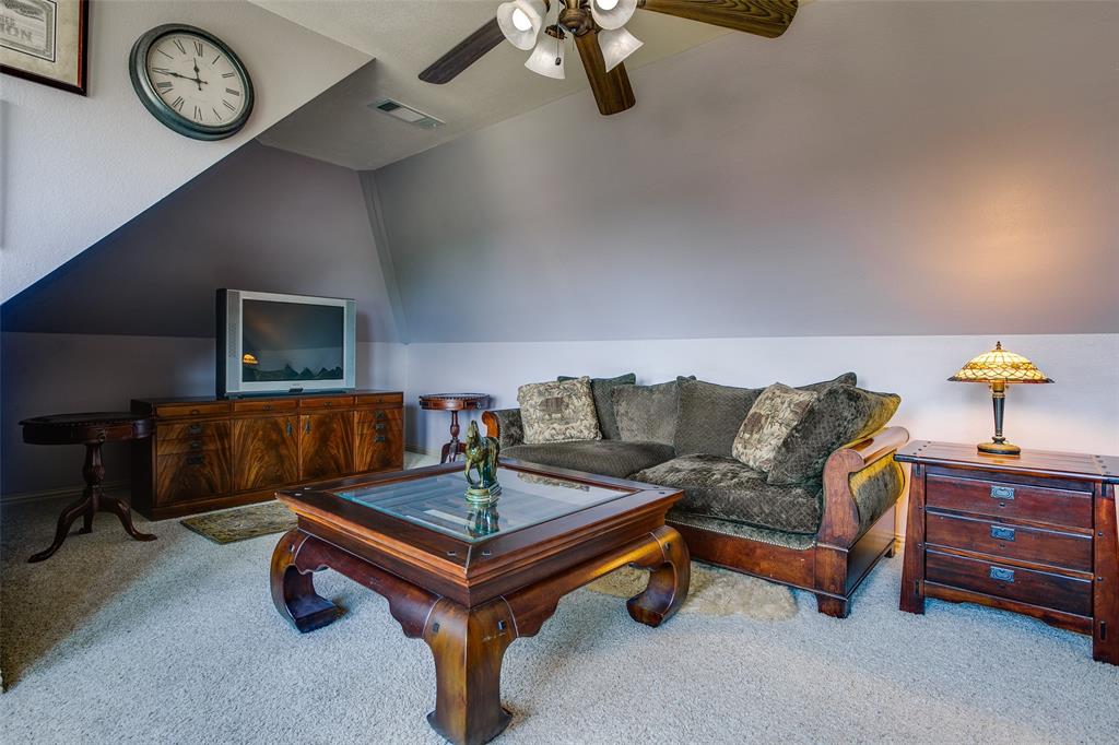 10044 Dennehy Drive Talty, TX 75126 - Photo 26 of 40 a living room with furniture and a clock