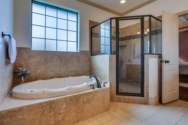 a bathroom with a tub and shower