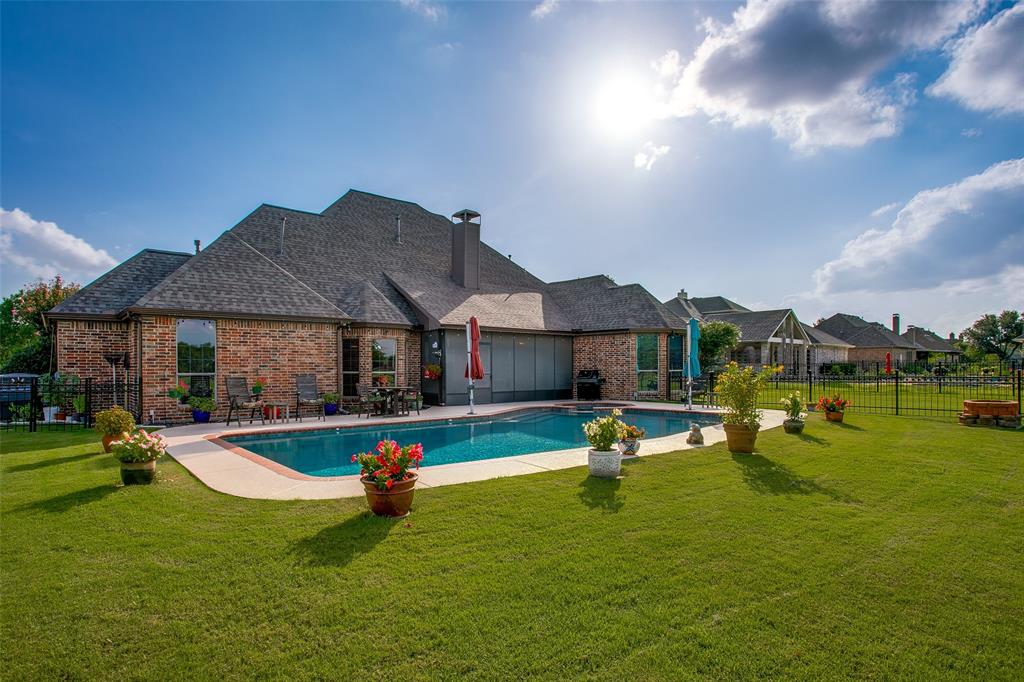 10044 Dennehy Drive Talty, TX 75126 - Photo 33 of 40 a view of pool with lawn chairs and a fire pit