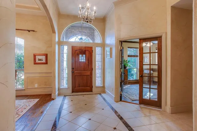 a view of a entryway door with chandelier