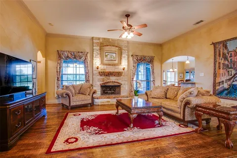 a living room with furniture fireplace and flat screen tv