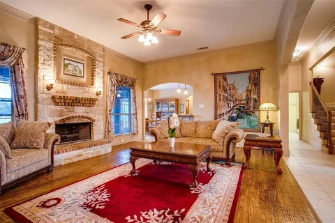 a living room with furniture fireplace and a table