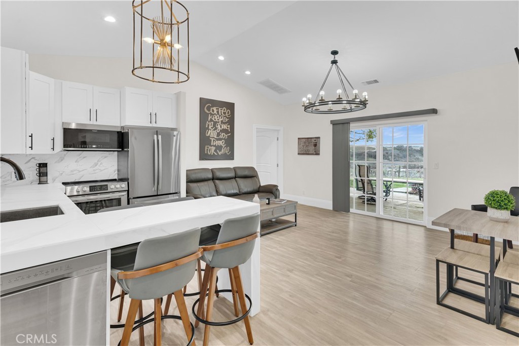 4295 Union Road Paso Robles, CA 93446 - Photo 13 of 27 a kitchen with stainless steel appliances wooden floor dining table and chairs