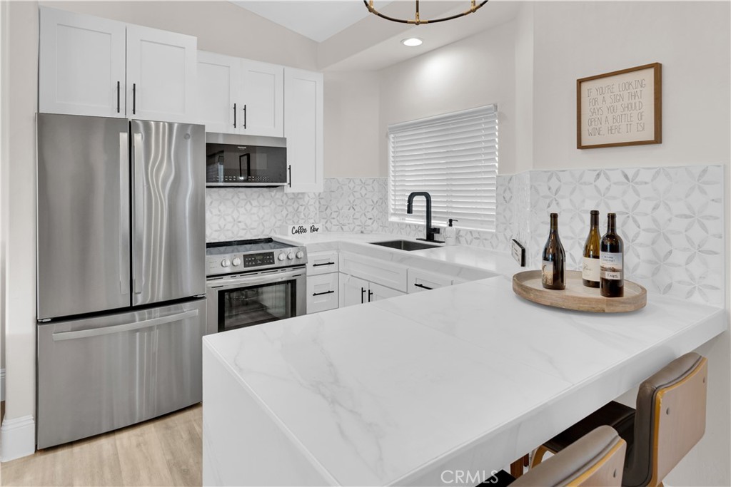 4295 Union Road Paso Robles, CA 93446 - Photo 16 of 27 a kitchen with white cabinets and stainless steel appliances