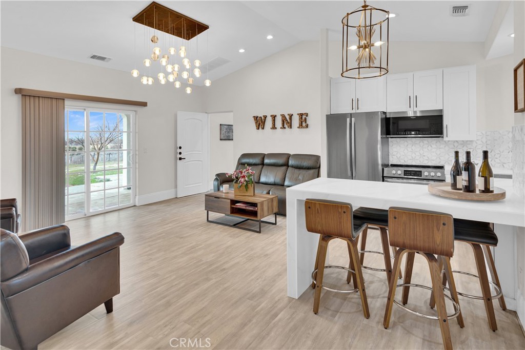 4295 Union Road Paso Robles, CA 93446 - Photo 4 of 27 a living room with furniture a chandelier and a flat screen tv