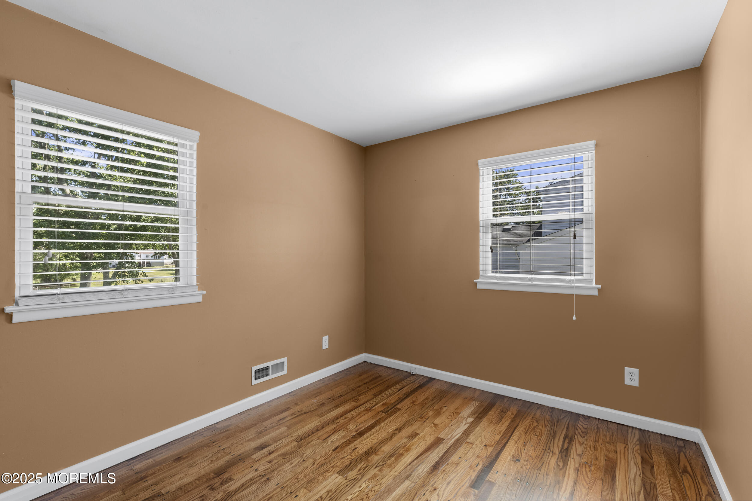 18 Hampton Road Howell, NJ 07731 - Photo 11 of 32 a view of an empty room with wooden floor and a window