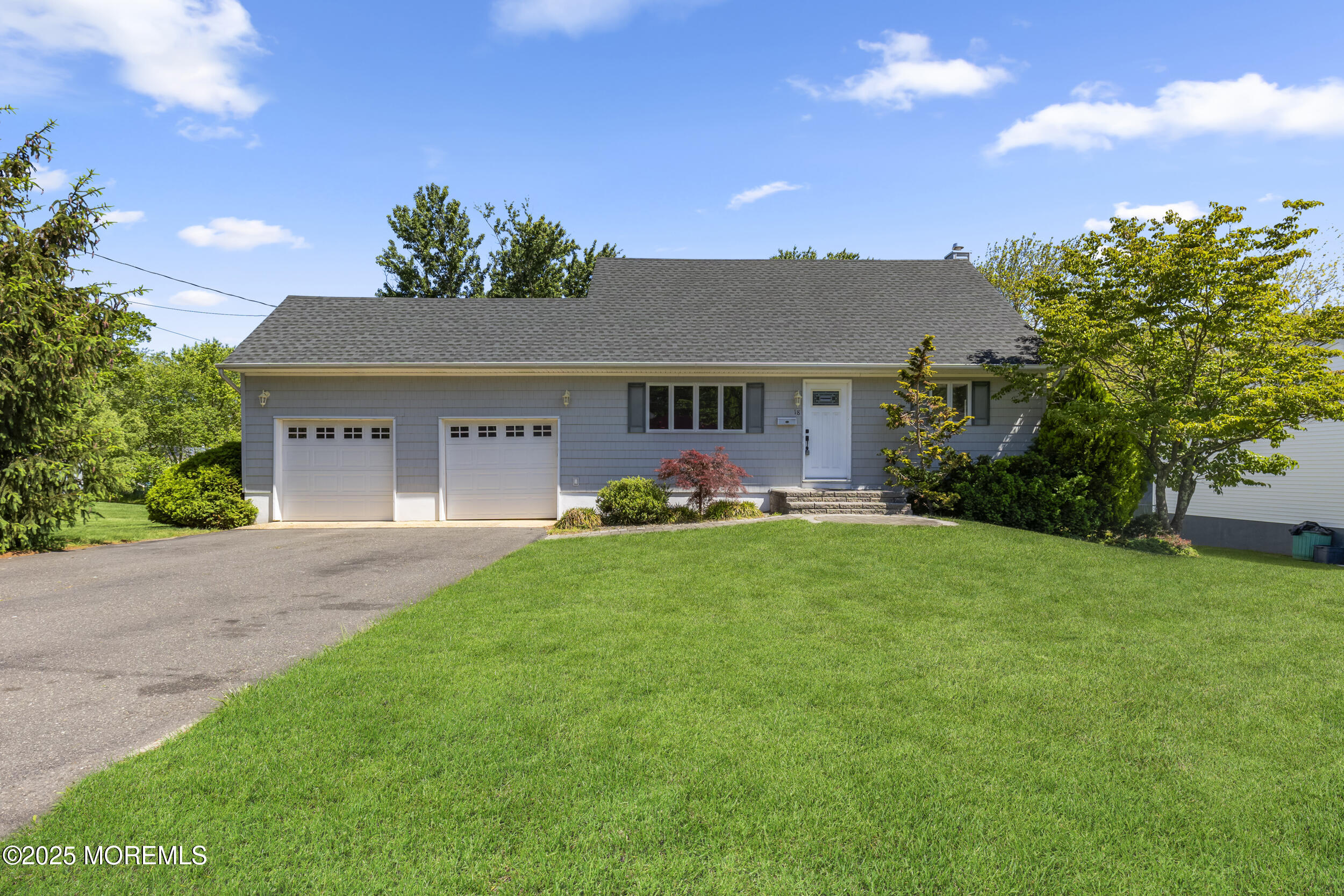 18 Hampton Road Howell, NJ 07731 - Photo 2 of 32 a front view of a house with a yard and a garage