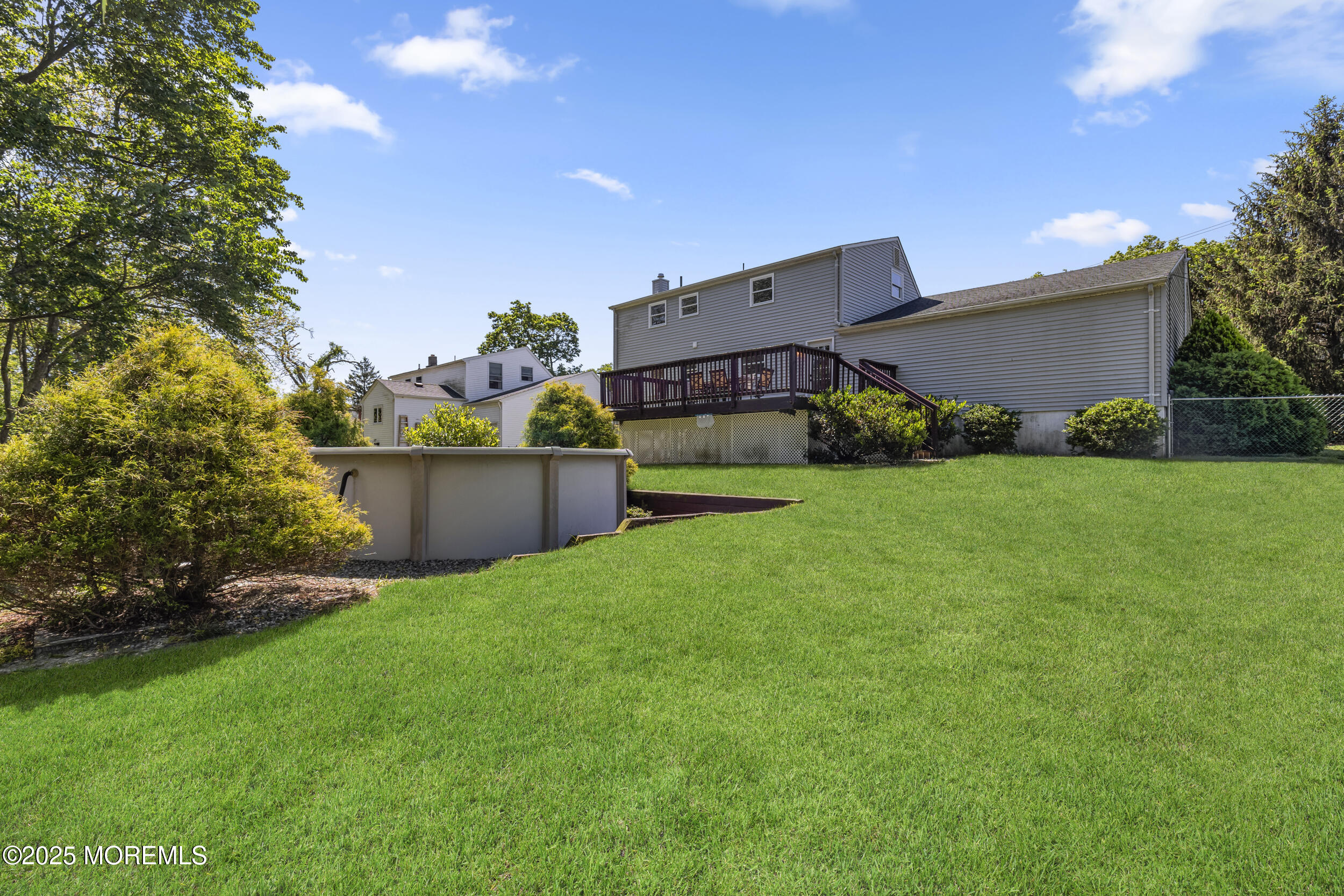 18 Hampton Road Howell, NJ 07731 - Photo 29 of 32 a backyard of a house with plants and a garden