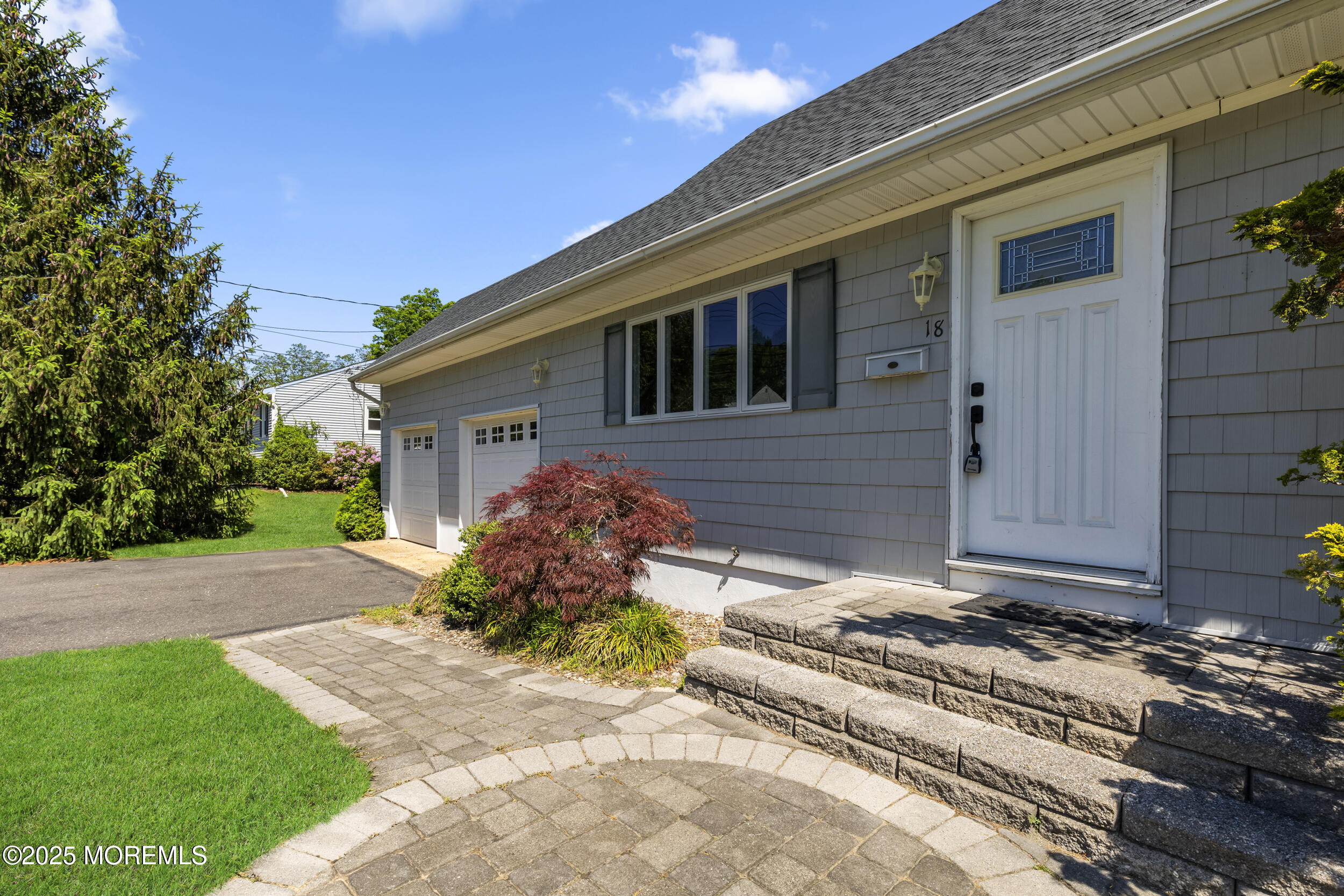 18 Hampton Road Howell, NJ 07731 - Photo 4 of 32 a front view of a house with a yard and garage