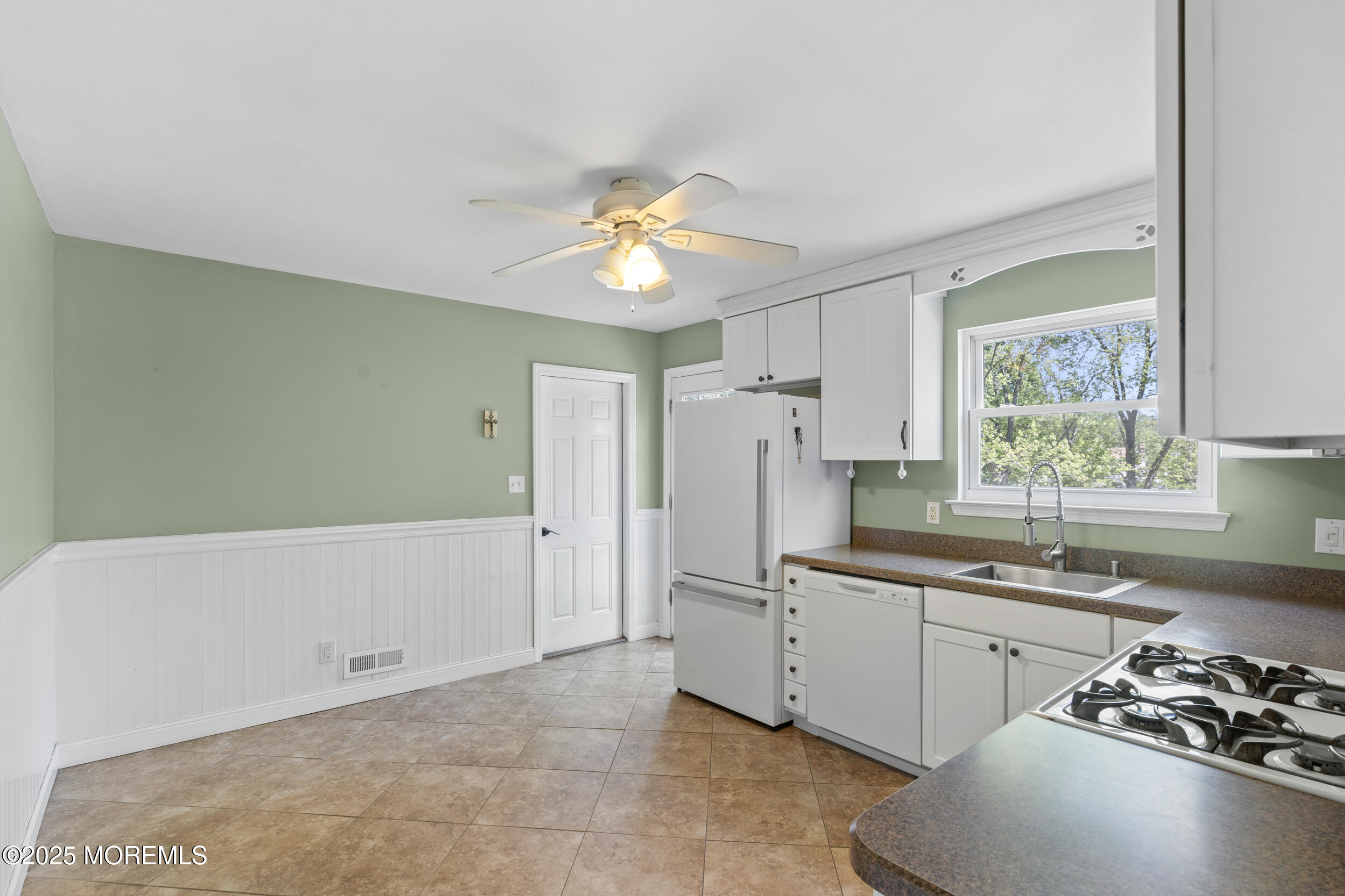 18 Hampton Road Howell, NJ 07731 - Photo 7 of 32 a kitchen with a sink a refrigerator and a stove
